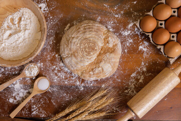 Top View of Bakery Ingredient with a Bread on the Wooden Background