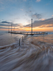 Sunrise view of Mona Vale rock pool with high tide.