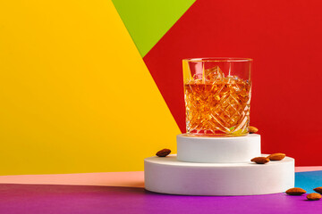 French connection alcoholic cocktail with cognac and amaretto liqueur. Modern style still life on fashionable multicolored background