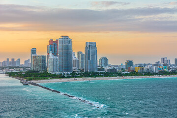 Miami beach and city scape on sunset sky