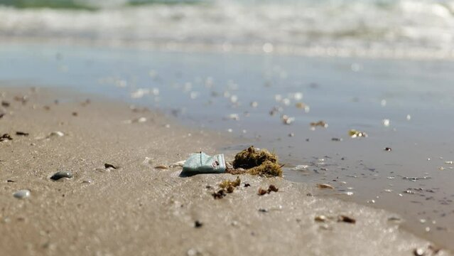 Blue Disposable Medical Procedure Face Mask 
washed up on Australian beach shore
