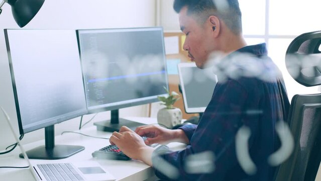 Young Asian man, developer programmer, software engineer, IT support, working on computer to check coding in bugging system