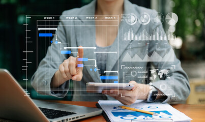 Businessman hand Project manager working and update tasks and Gantt chart scheduling virtual...