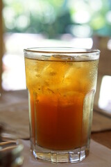 Close up a glass of ice tea with bokeh background.