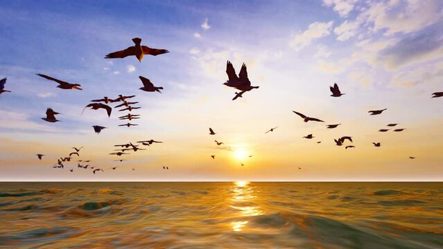 Flock of seagulls flying low over the sea at sunset