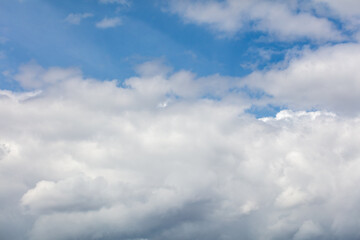White clouds on the blue sky as a background.