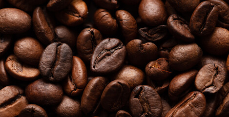 Grains of black coffee as a background.