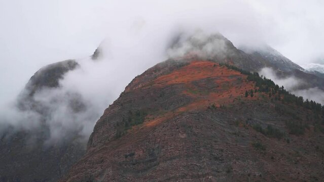 Clouds above the mountain peaks during the storm at Jispa in Lahaul Spiti district at Himachal Pradesh in India. Clouds covers the peaks of the mountains. Natural mountain background. 