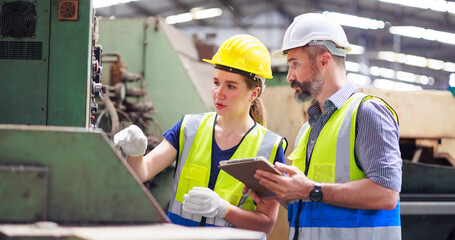 Service and maintenance concept. Service manager male engineer explain the procedure for using the correct metal robot machine at lathe industrial factory.