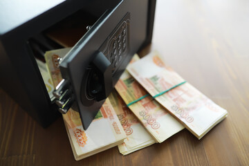 money in a residential safe close-up photo. Deposit in cash. Russian rubles are in the safe