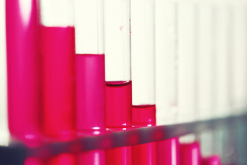 Microscopic examination of blood. Test tubes with red liquid on the laboratory table.