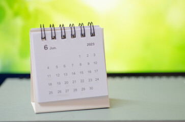 White calendar on green background.