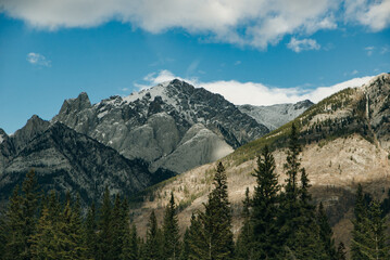 Scenic road through the Canadian Rockies, surrounded with rocky mountains. Taken in Banff National Park, Alberta, Canada