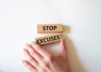 Stop excuses symbol. Concept words Stop excuses on wooden blocks. Businessman hand. Beautiful white background. Business and Stop excuses concept. Copy space.