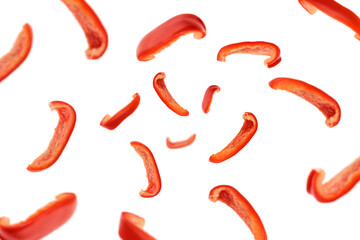 Falling sweet pepper slices, paprika, isolated on white background, selective focus