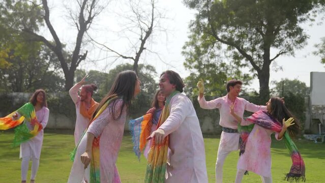 Indian people celebrating Holi festival in a park