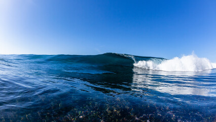 Ocean Wave Crashing Shallow Reef Swimming Blue Surface Sea Water Photograph.