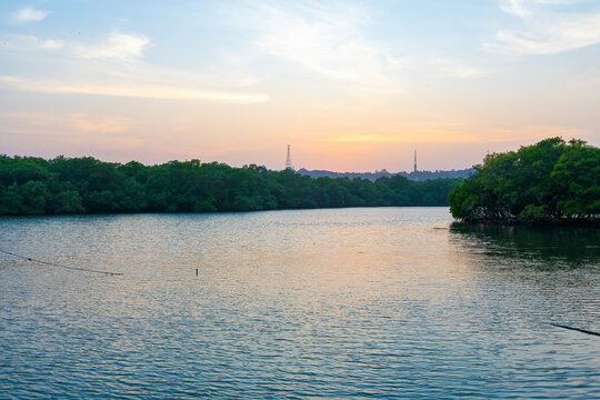 A beautiful sunset with a colorful sky above a river is a sight to behold. The sky is filled with hues of oranges, yellows, pinks, and purples, casting a warm glow over the river.