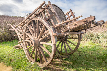Fototapeta na wymiar Ancienne charrette en bois, transportant un tonneau