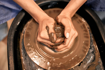 female hands sculpt clay, focus on hands close up