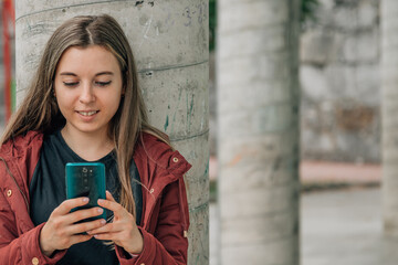 student at school looking at mobile phone