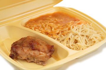 Chicken and pasta in a plastic box for delivery.
