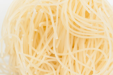 Intricate patterns of boiled noodles.