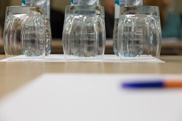 Three inverted empty glasses on a wooden surface.