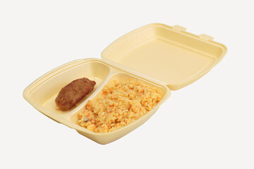 Cutlet and rice in a plastic box for delivery.