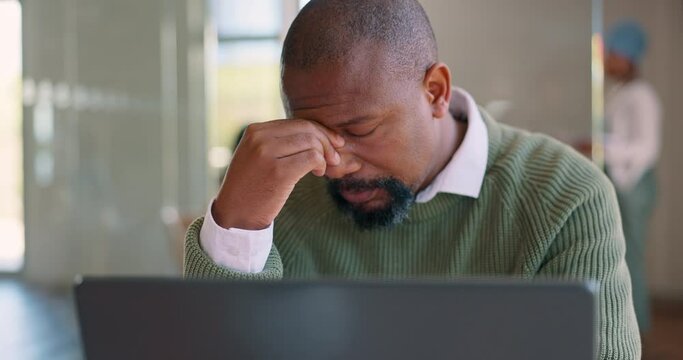 Laptop, stress headache and businessman typing review of finance portfolio, stock market trading or economy data. Depression, investment and tired black man with nft, forex or bitcoin mining burnout