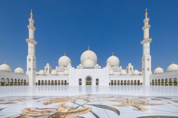 Symmetrical view of the main courtyard of the Sheik Zayed grand mosque in Abu Dhabi with the prayer...