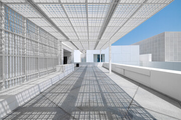The modern entrance to Abu Dhabi Louvre museum, with a white marble walkway and a geometric square metal grid for shade