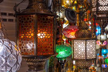Shopping for colorful traditional Middle Eastern lamps for sale in an Istanbul Bazaar, Turkey.