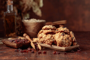 Oatmeal raisin cookies on a brown table.