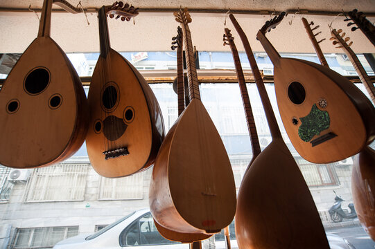 Handmade Oud hanging inside the window display of Muzik Evi, Istanbul. Bağlama and Oud. Turkish musical instruments 