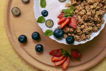Granola - a healthy breakfast dish, as well as a traditional snack of rolled oatmeal, nuts and honey, with yogurt and fruit