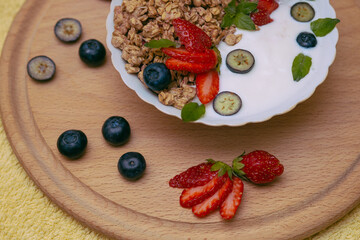 Granola - a healthy breakfast dish, as well as a traditional snack of rolled oatmeal, nuts and honey, with yogurt and fruit