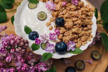 Fototapeta premium Granola - a dish for a healthy breakfast, as well as a traditional snack of rolled oatmeal, nuts and honey