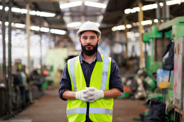 Portrait Professional mechanical engineering hispanic male in white safety hard hat helmet and look at camera at metal factory.