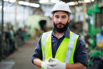 Portrait Professional mechanical engineering hispanic male in white safety hard hat helmet and look...