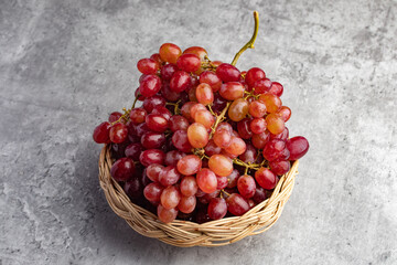 fresh red grapes on a gray background