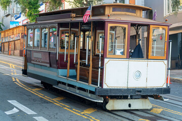 Naklejka premium Cable car in historic districts in san francisco california deep in heart of city with white color and wooden accents