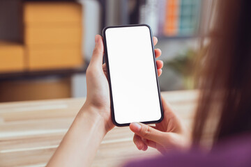 Hand holding digital smartphone mockup of blank screen. Take your screen to put on advertising.
