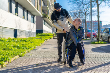 Disabled person walking having fun with friend in wheelchair on the street
