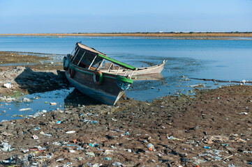 Abandoned boats on the receding shoreline of the Euphrates River in the South of Iraq. Low rain...