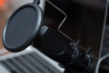 Obraz na płótnie Canvas close-up of a studio microphone with a pop filter. Recording a podcast
