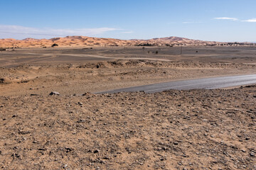 A winding road through the vast Sahara desert of Morocco