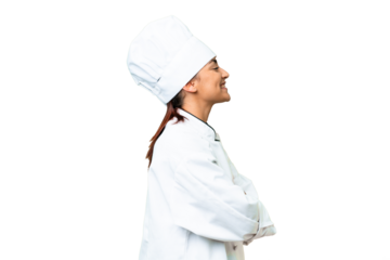 Young woman Chef over isolated chroma key background in lateral position