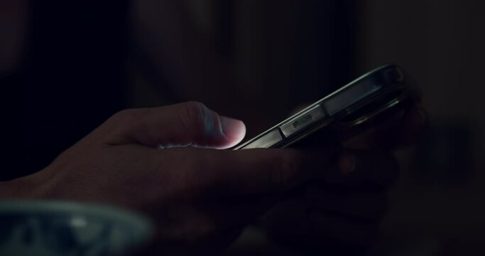 Side view of woman use smartphone, screen lit fingers swipe and scroll through content on the screen. Push buttons, follow links. Nighttime phone using