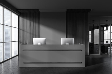 Grey reception interior desk with two computers, panoramic window